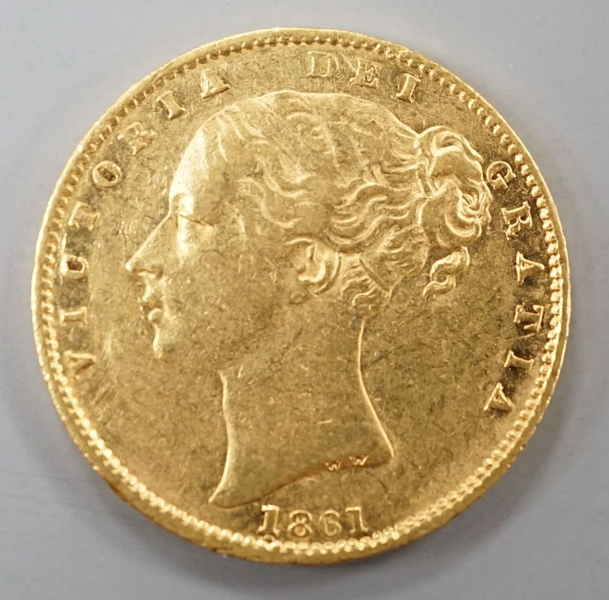 A Victorian 1861 gold young head shield back sovereign, London Mint (1 over lower 1).